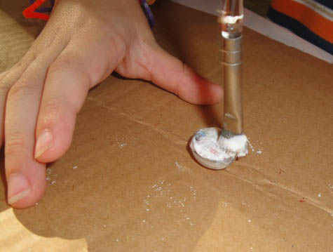 painting mod podge onto back of picture cut out