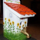 white birdhouse with red roof and spigot for perch
