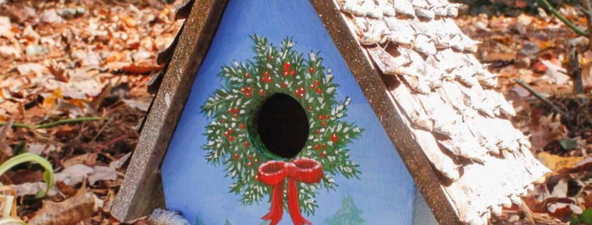 birdhouse with winter tree scene hand-painted, pine cone roof, and branch for perch