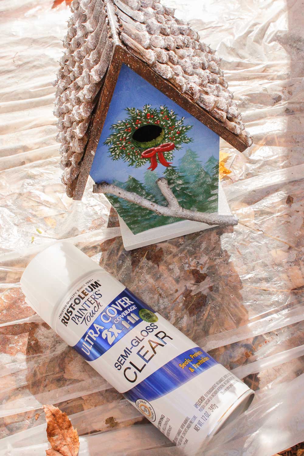 birdhouse with a can of rustoleum clear coat in front of it