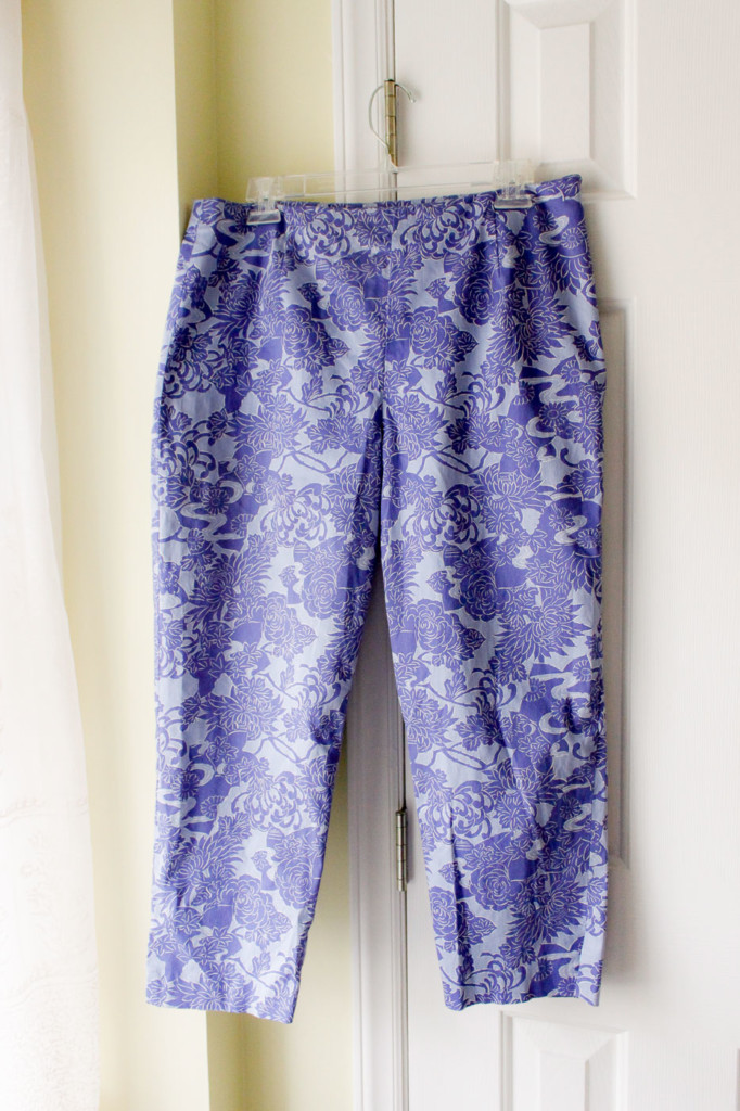 Purple print pants hanging on a hanger.