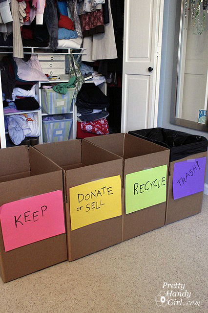 cardboard boxes in front of closet labeled keep, donate/sell, recycle, trash