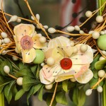 Close up two yellow scrapbook flowers on wreath