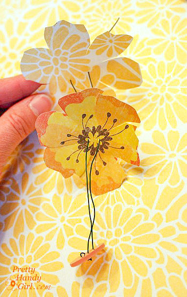thread paper flowers and button onto wire