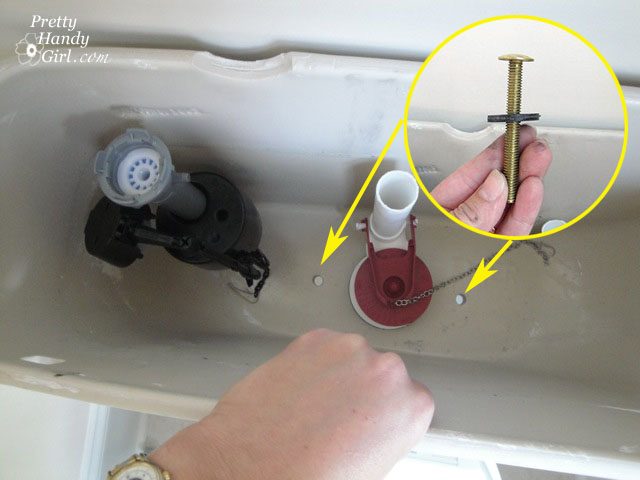 Insert_bolts_into_tank Toilet Repairs Replacing the Overflow Tube and Flapper