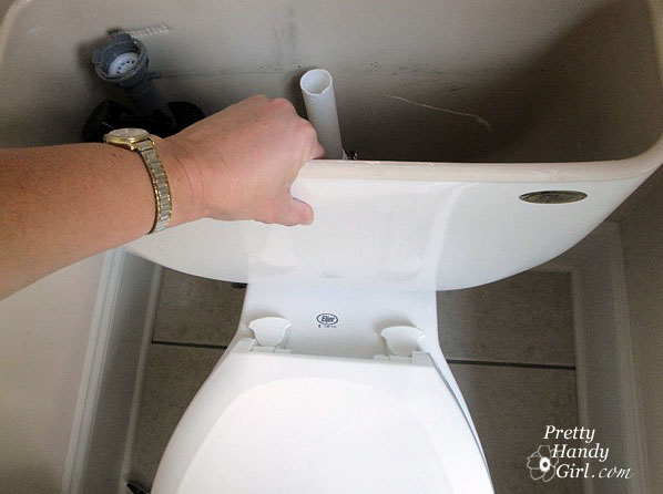 set_tank_back_on_toilet Toilet Repairs Replacing the Overflow Tube and Flapper
