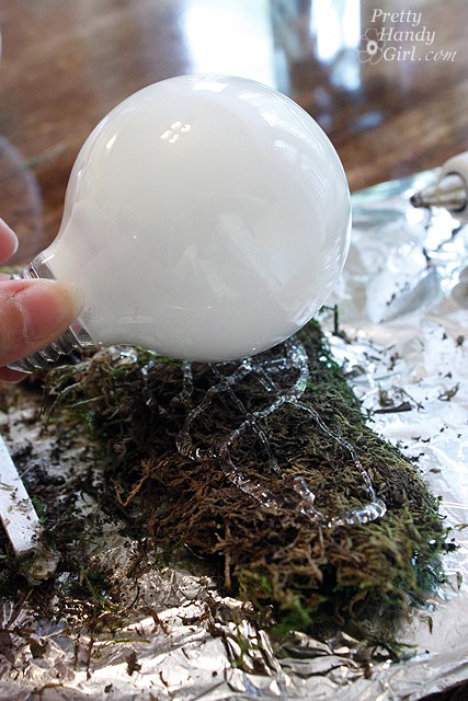 gluing_moss_to_light_bulb