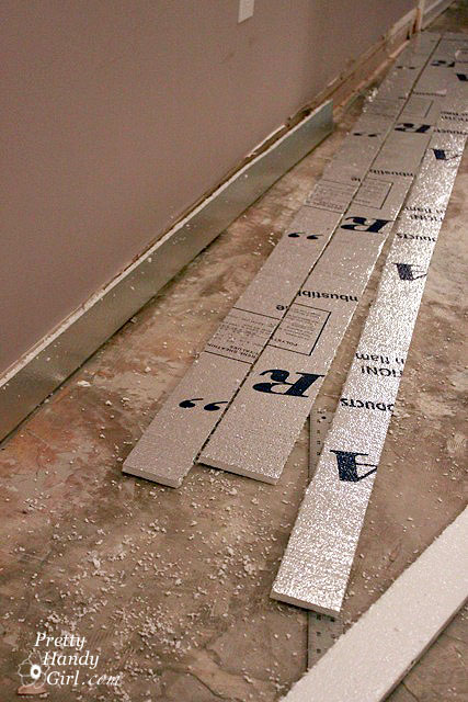 cutting_strips_of_foam Patch and Level a Concrete Subfloor