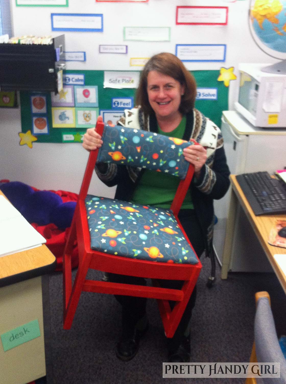 happy teacher posing with a refinished chair