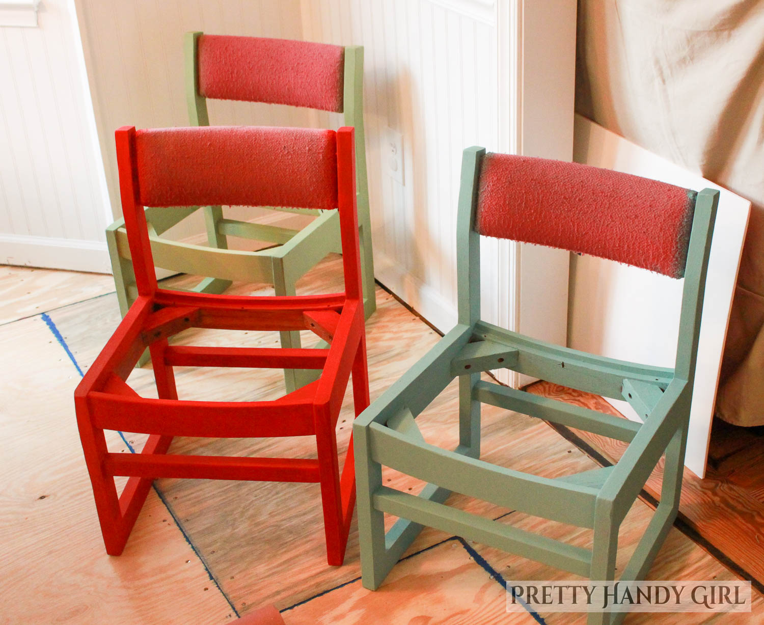 three this end up style chairs with a new coat of paint in red, green, and blue