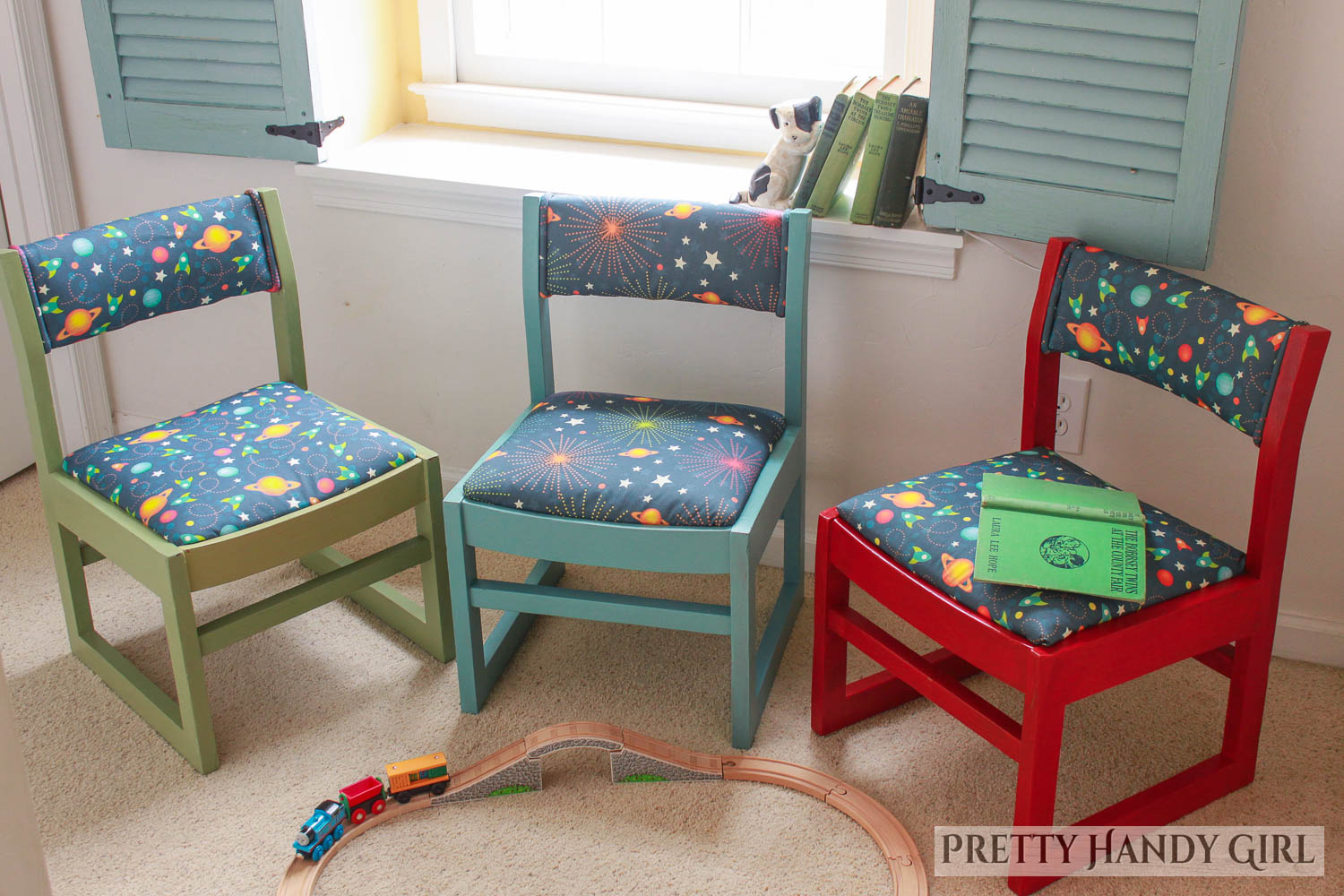 three this end up style chairs refinished with colorful frames and space themed fabric