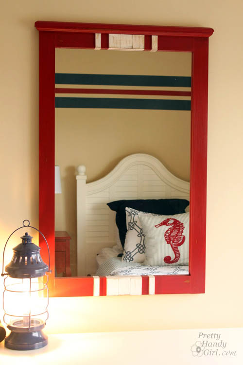 Some red milk paint, lattice and glue transform this $15 find into a charming racing stripe mirror perfect for a boys' room! | thrift store makeover | DIY mirror | mirror tutorial | #prettyhandygirl #DIY #tutorial