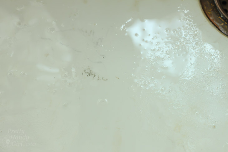 dark scratched cast iron sink