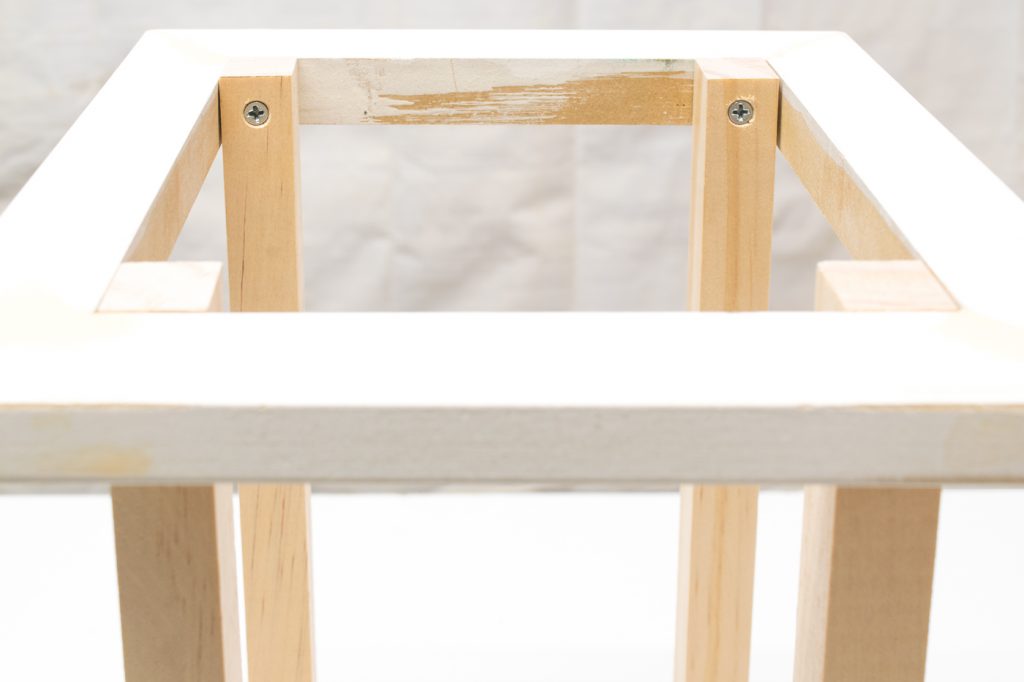 Attach the top frame to the pillars of the candle lantern.
