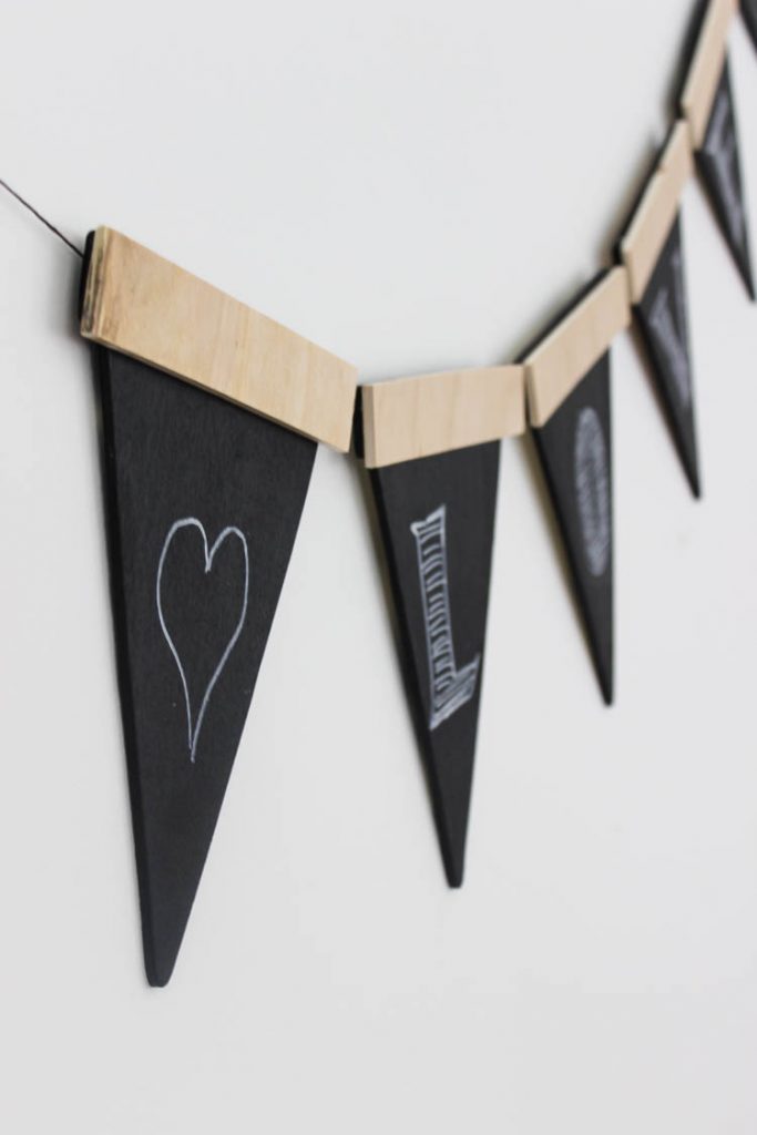 Love this twist on the traditional party banners! This rustic wooden version can be used again and again.