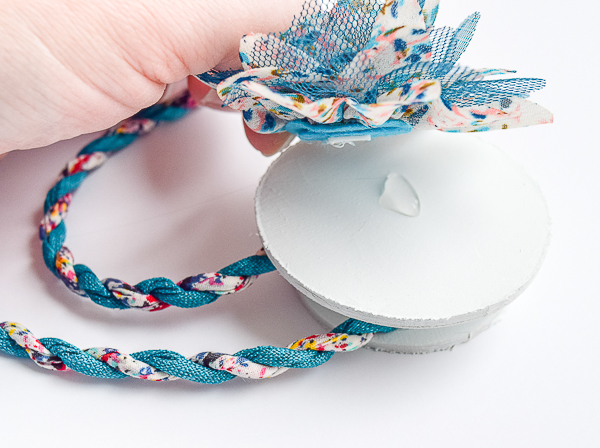 Add your decoration to the front half of the curtain tie backs with hot glue.
