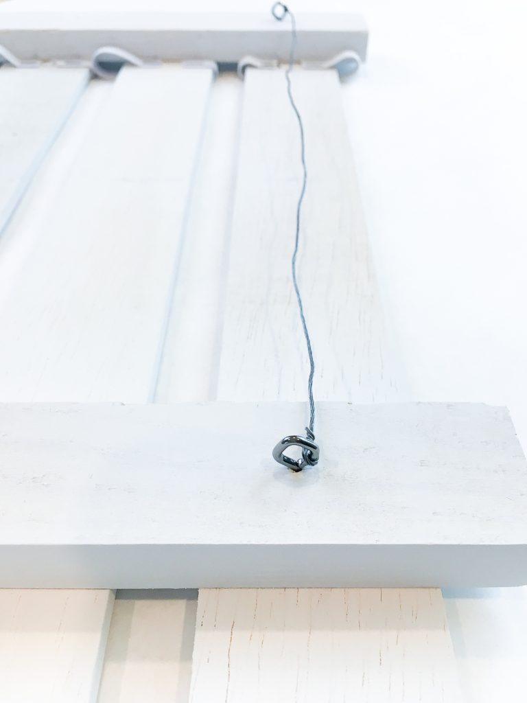 Add your preferred picture hanging hardware to the back of your karate belt display rack.