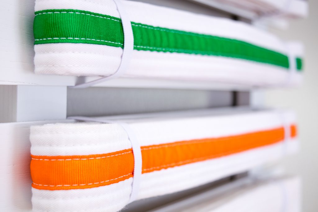 Elastic bands hold the karate belts in place.
