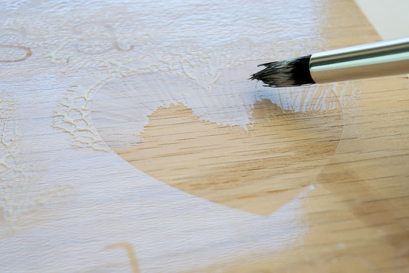 Apply wood glue to the voids in the stencil, ensuring even coverage on all the letters of the teacher sign.