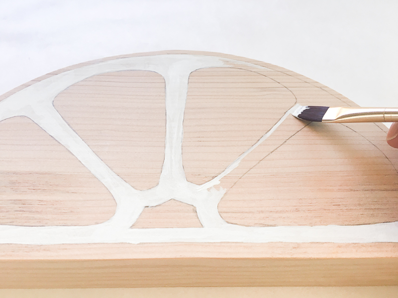 Paint the white sections of the lemon and lime first.