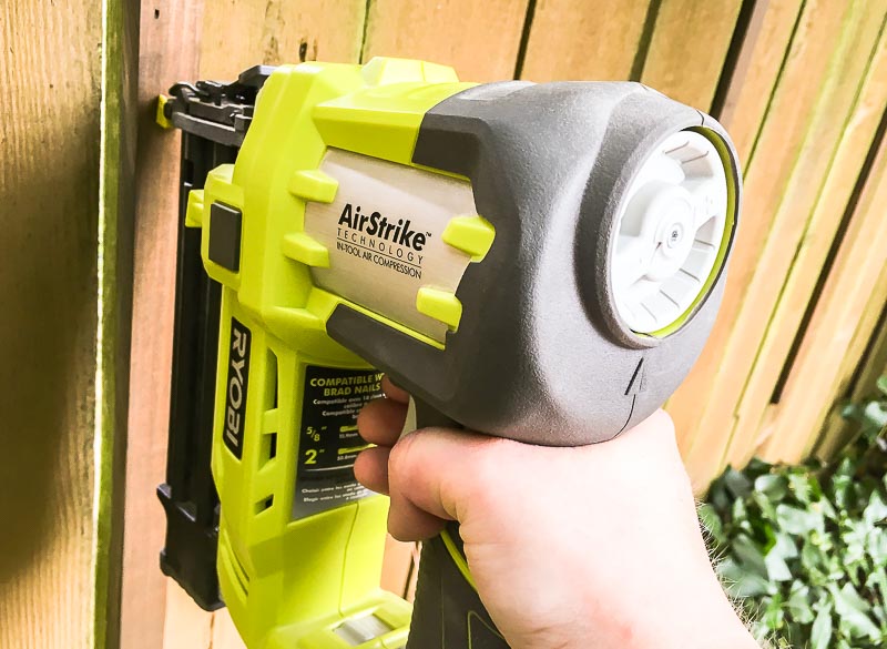 Use a nail gun to attach the vertical pieces directly to the fence.