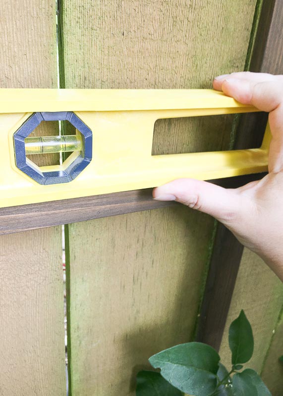 Use a level to make sure the bottom rows are straight.