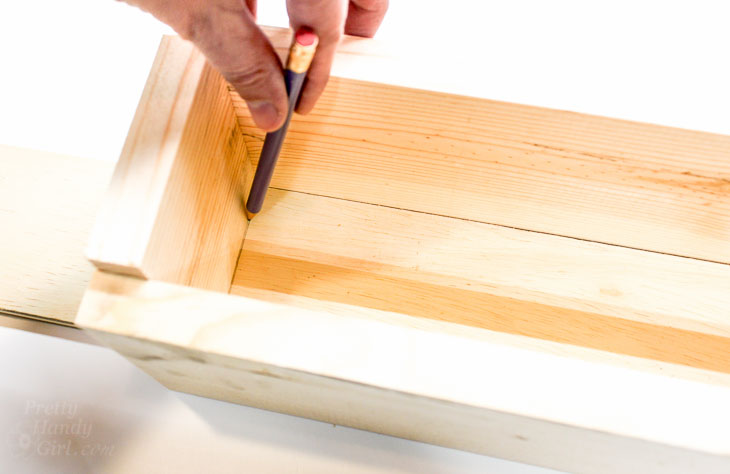 Mark cut line with pencil on trough bottom.