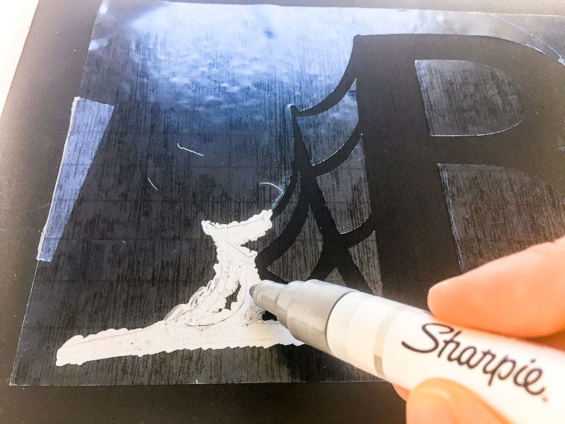 I used a silver paint marker to fill in the stencil of the Halloween sign.