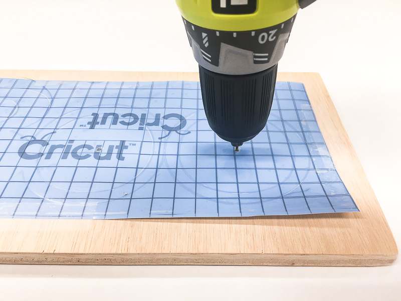 Drill a hole to mark the center of the O's on your Halloween sign.
