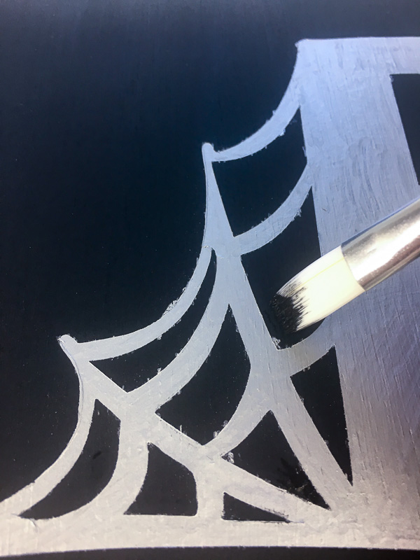 Touch up any areas that bled through with black paint.