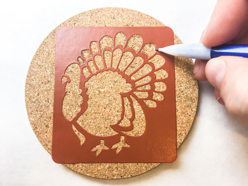 Trace around the edge of the stencil onto your cork trivets or coasters.