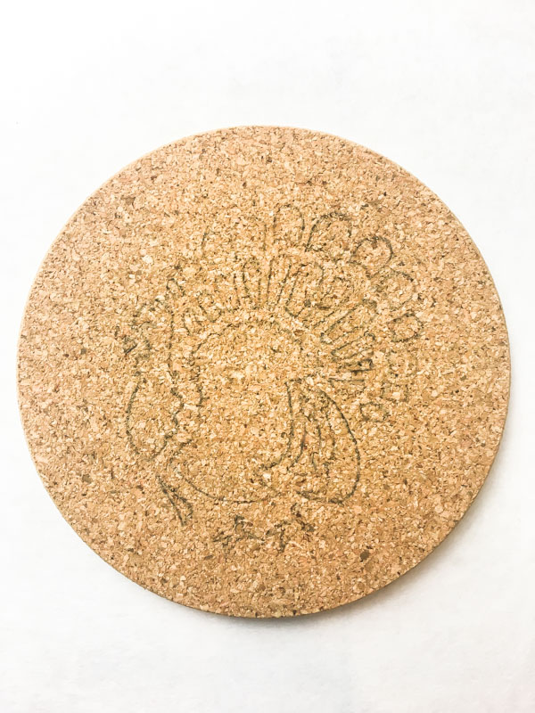 Remove the stencil to reveal your stenciled design on the cork trivets.