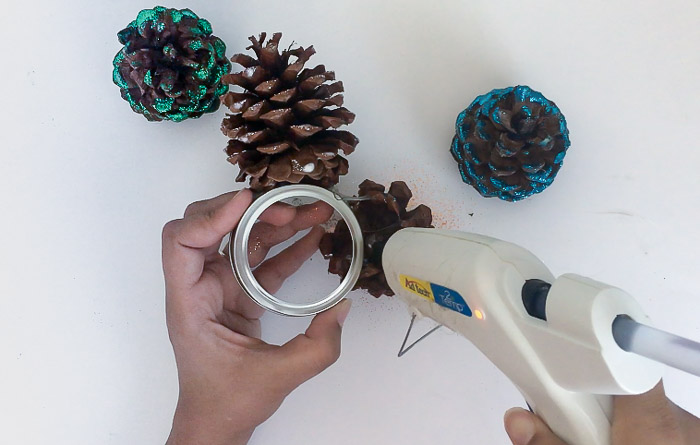 Making a glittered pine cone door hanger