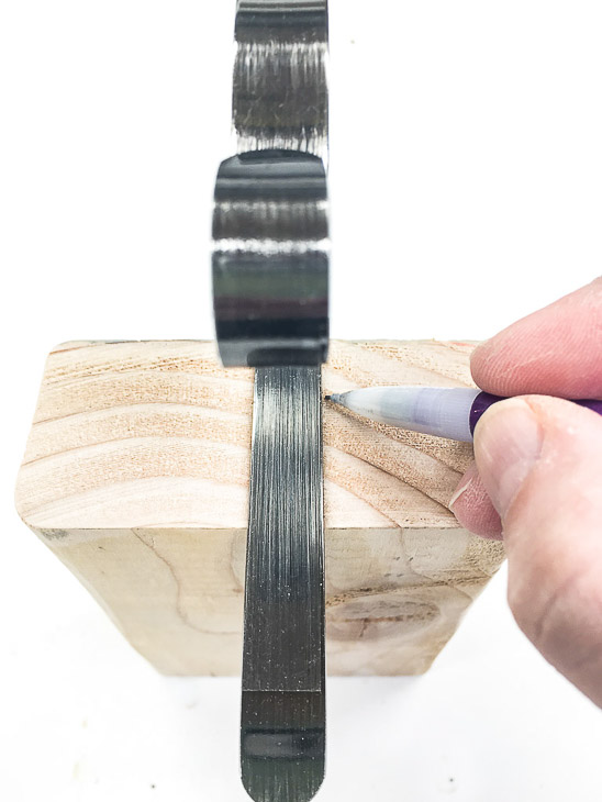 Mark the placement for your mantel hooks.