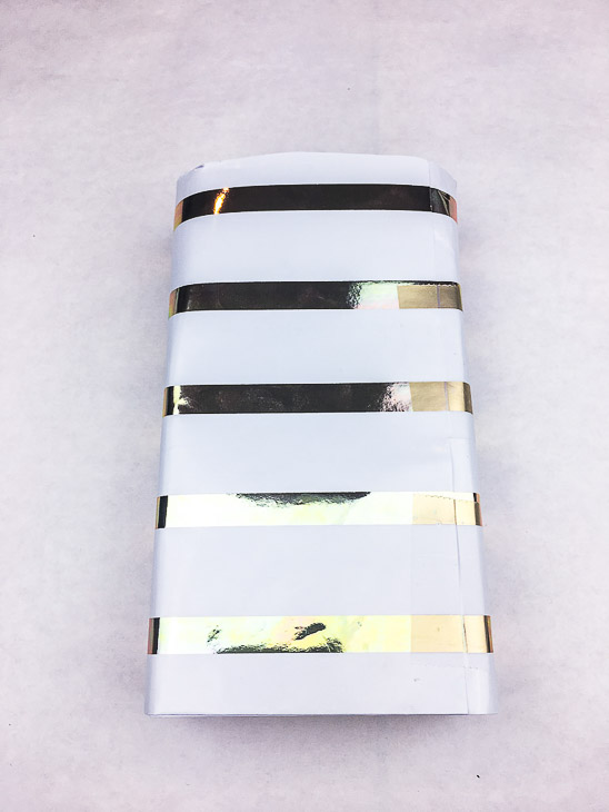 Wrap the wrapping paper around the block and tape in the back.