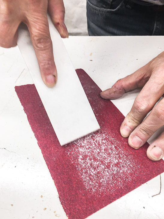 Sand the edges of the marble to match the curve of the routed edge.
