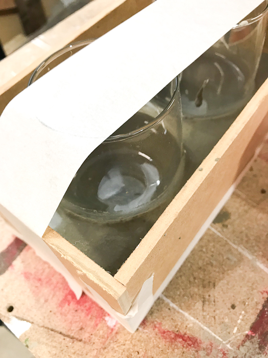 DIY Concrete Desk Organizer - use tape to secure the tumblers in place then pour concrete around them
