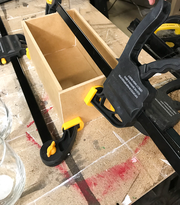 DIY Concrete Desk Organizer - use wood glue and clamps to assemble box mold