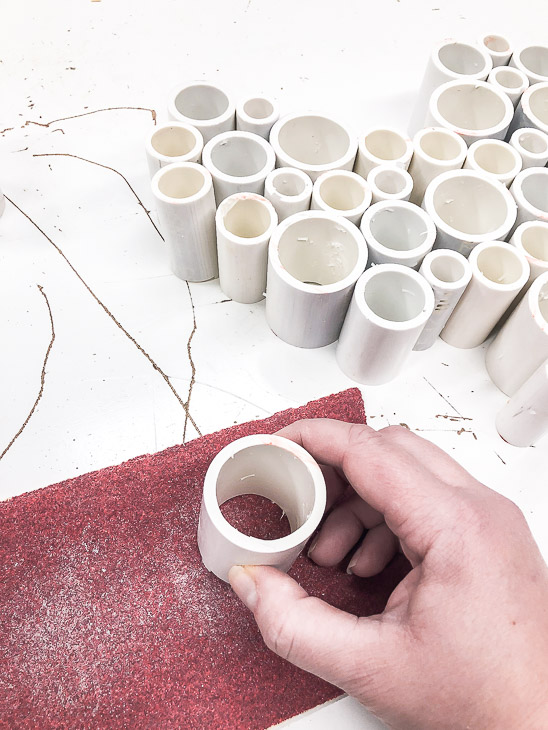 Sand each end of the cut PVC pipe with 80 grit sandpaper.