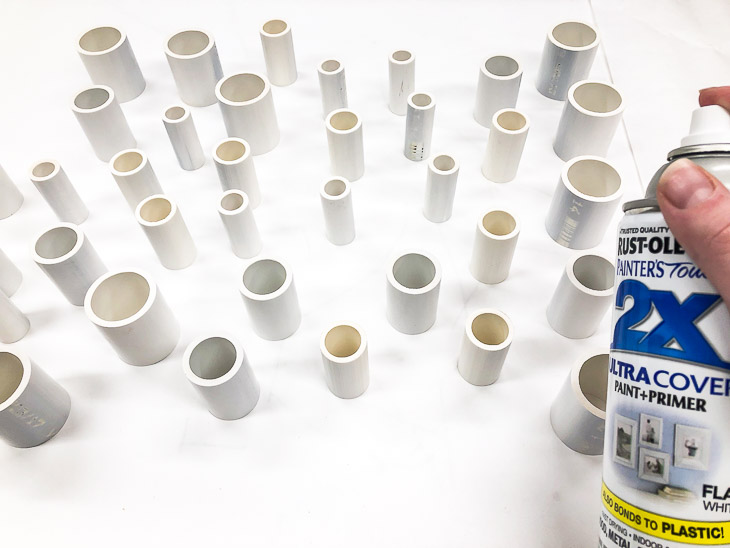 Give all the pieces of PVC a few coats of white spray paint.