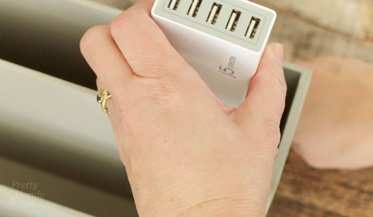 Slide charger into slot and adhere with double sided velcro.
