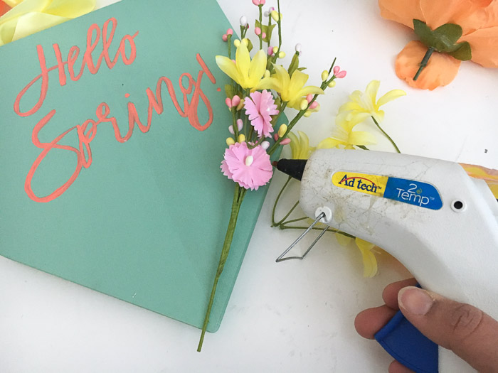 attaching flowers to the spring plaque