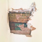 bead board peeking through drywall hole