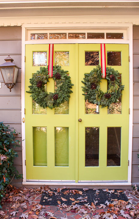 double lime green front door with Christmas wreaths