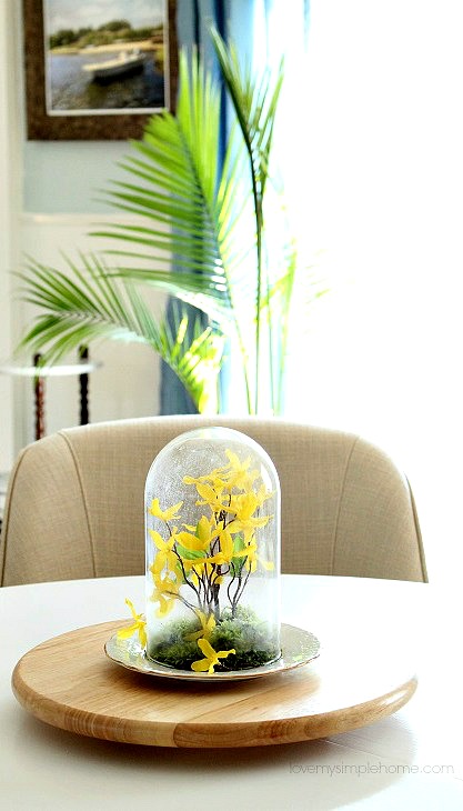 Spring table centerpiece yellow flowers in cloche