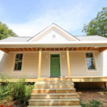Off white farmhouse exterior house color, green door