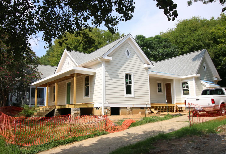 Triple A Construction house white and off white siding
