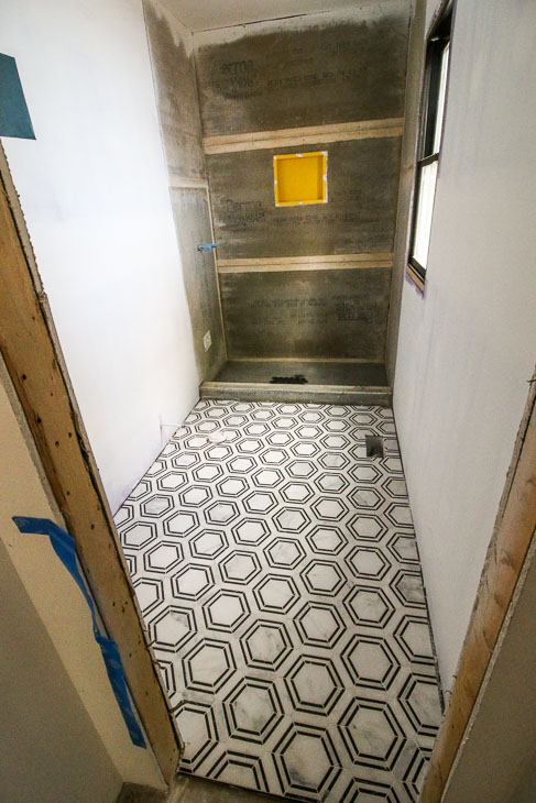 Beautiful marble outlined black white hex tiles in master bathroom