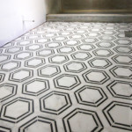 The Builder Depot Carrara Venato Hexagon Nero Strip Marble Mosaic Tile installed on bathroom floor