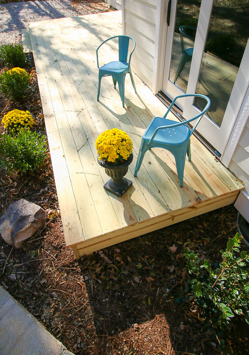 lovely photo of deck and low landscaping plants around deck